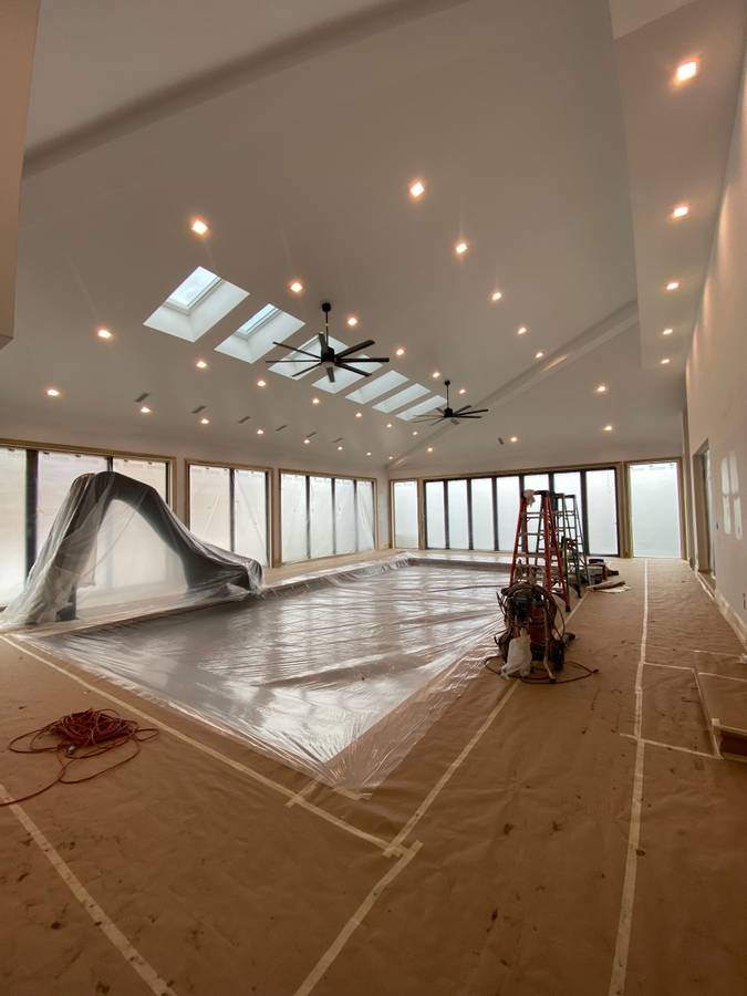 Vaulted great room with skylights, masked and protected before painting