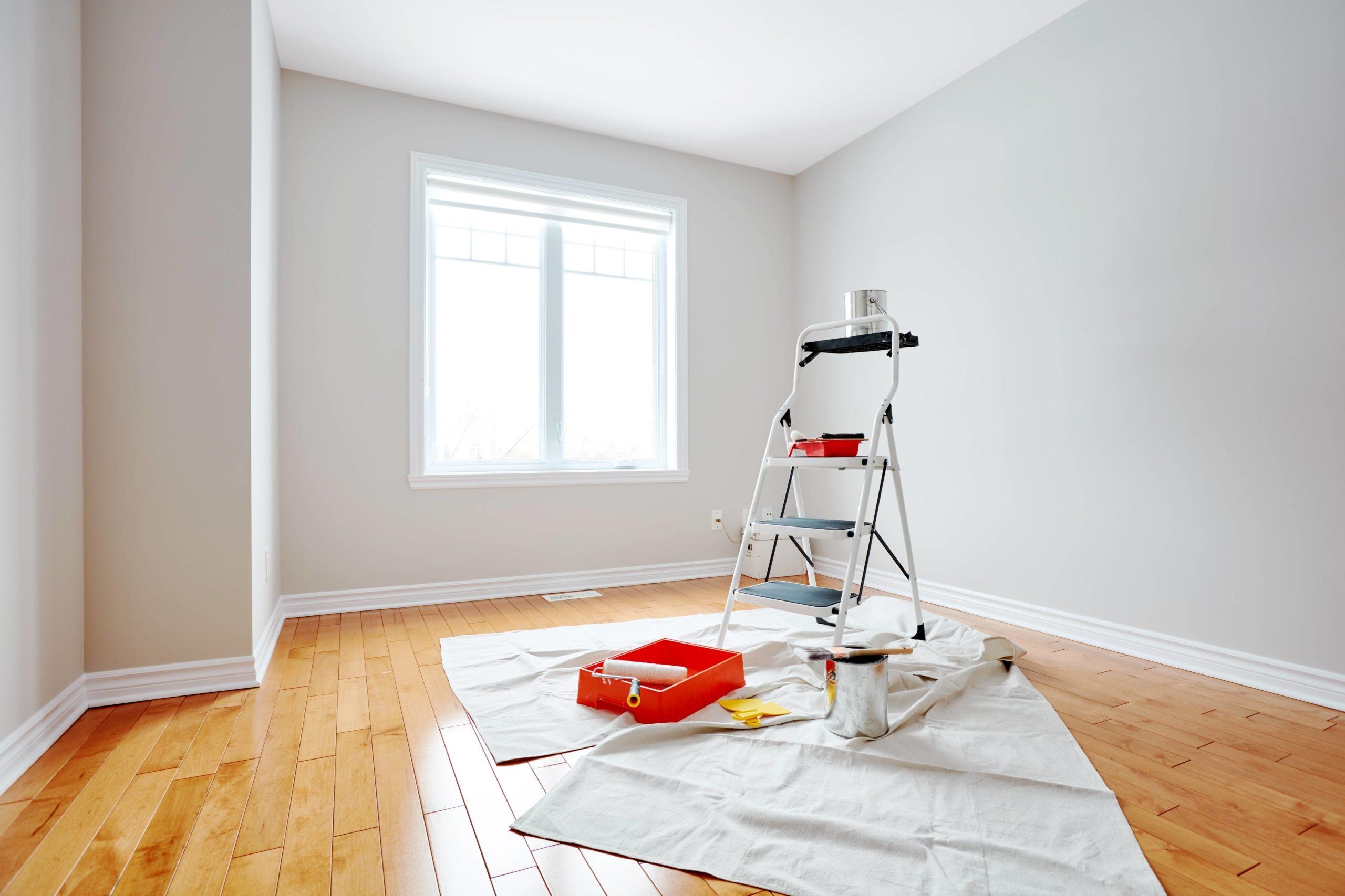 Interior room prepared for painting with drop cloths