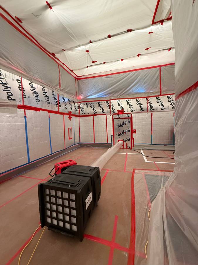 Commercial interior sealed with plastic containment and floor protection